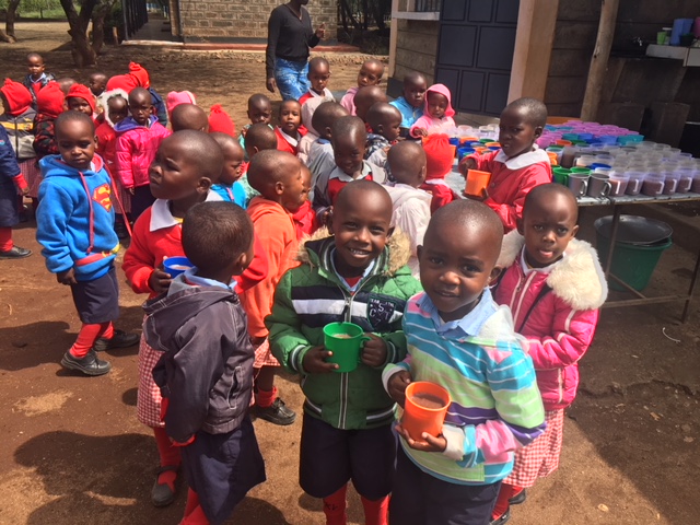 Children enjoying their mid-morning break. They are well wrapped up, as not everywhere in Africa is warm!